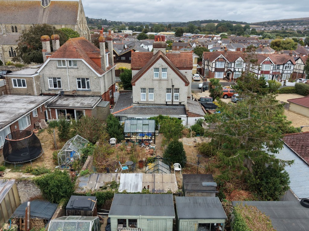 Lot: 87 - FREEHOLD DETACHED FORMER GUEST HOUSE ARRANGED AS FOUR FLATS ON GOOD SIZE PLOT WITH PARKING - Drone shot of the rear